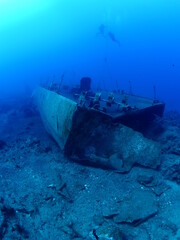   ship wreck underwater deep sea bottom metal on ocean floor scuba divers to explore