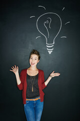 If theres a better way, shell find it. Studio shot of a young woman posing with a chalk illustration of a lightbulb against a dark background.