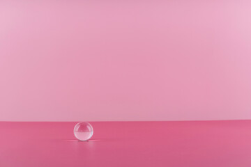 Cosmetic background podium for product presentation. Pink backdrop with transparent sphere decor,...