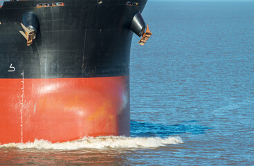 Front view of bow and anchors of large bulk cargo ship. Performing cargo export and import...