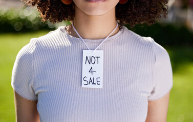 A power than can transform the world. Shot of a unrecognizable woman wearing a sing on her neck in...