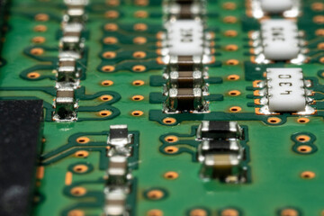 Computer motherboard. Capacitors, transistors, micro-components close-up, macro photo.