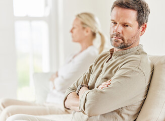 Regrets are relentless. Shot of a young couple looking annoyed after a disagreement on the sofa at home.
