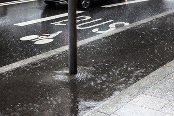 Heavy rain on street marking . Bus station in the city 
