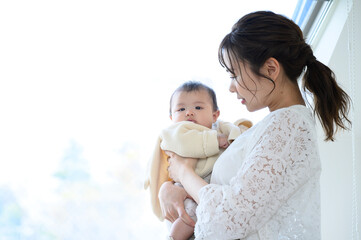 A mother stares out, exhausted from raising her child.