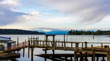 Marina at Sooke Harbor, BC, on a cloudy Spring morning with cloud-capped mountains on horizon.