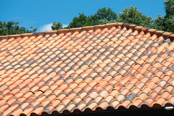 Old tiled roof with sky in background