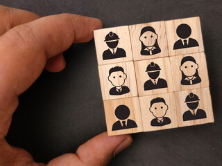 Wooden block with icons of a group of team workers. the concept of group relationships