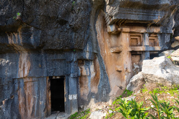 Lycian rock hewn tombs carved into mountainside in ancient Pinara city, Mugla Province, Turkey