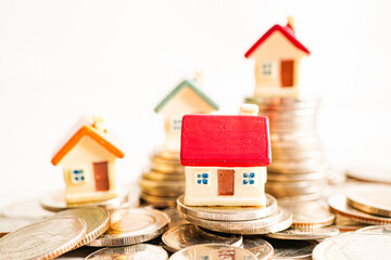 House on stack of coins, Investment property finance concept.