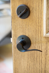 Open brown wooden door handle with lock