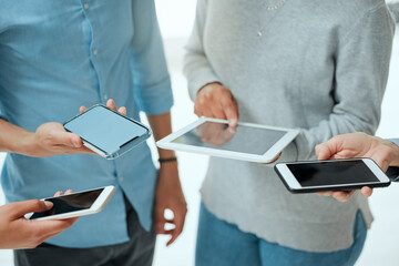 Well, we made some friends. Cropped shot of a group of unrecignizable businesspeople using their smart phones.