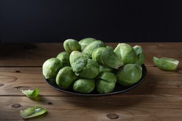 Brussels sprout on wood background. Brussel cabbage.