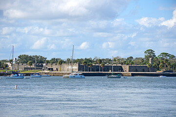 Boats anchored in the Matanzas river in front of Castillo San De Marcos Fort  near downtown St Augustine Florida