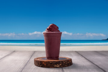 Ice Cream acai Cup on background tropical beach