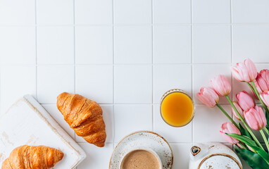 French Breakfast with Croissants, Orange Juice and Coffee with pink tulips