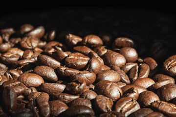 Close-up coffee beans on black background.