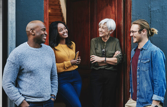 These chats always inspire us to do better. Shot of a group of businesspeople having a discussion together while standing outside their office building. - Powered by Adobe