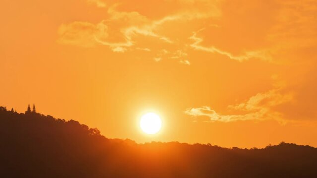 Timelapse of dramatic sunset with orange sky in a sunny day.