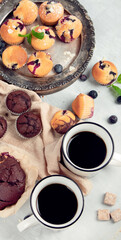 Muffins assortment on light background.