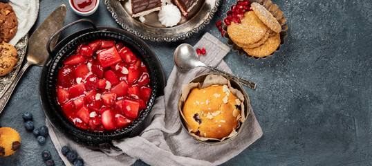 Dessert table with all kinds of cakes and snacks.
