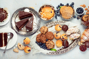 Dessert table with all kinds snacks on light background.