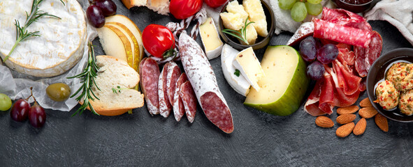 Appetizers assortment on dark background.