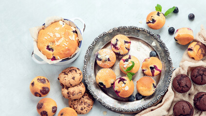 Muffins assortment on light background.