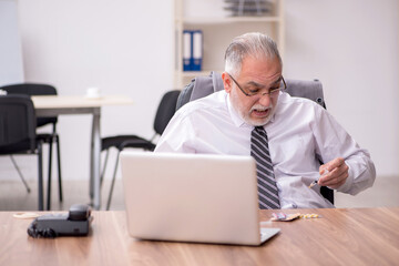 Aged male employee suffering at workplace
