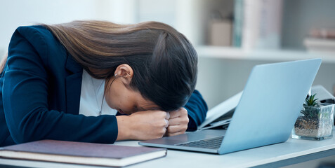 I cant get anything done right today. Shot of a young businesswoman sleeping at her desk in an office.