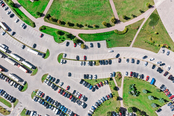Fototapeta premium urban public parking lot viewed from above in sunny summer day. aerial overhead view.