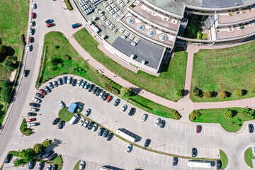cars standing on shopping mall parking lot. aerial view from above.