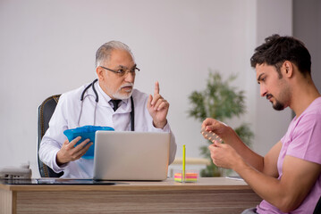 Young male patient visiting old male doctor