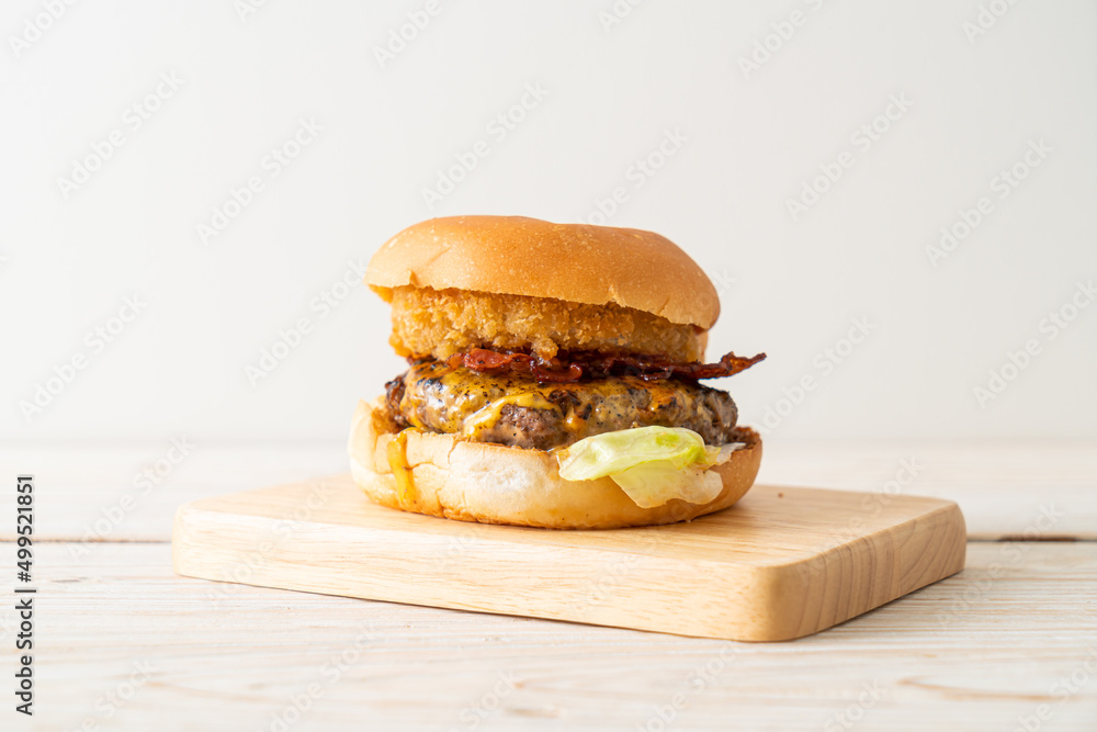 Sticker beef burger with cheese, bacon and onion rings