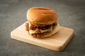 pork burger with cheese, bacon and onion rings