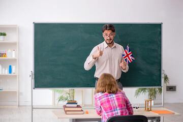 Young male english language teacher and redhead girl in the clas