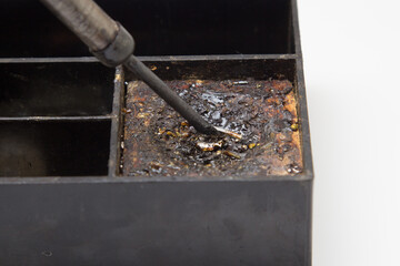 Old soldering iron on a white background