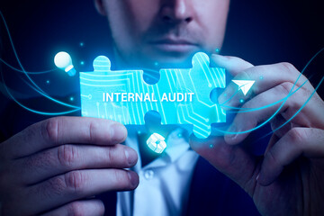 Obraz premium Business, Technology, Internet and network concept. Young businessman working on a virtual screen of the future and sees the inscription: Internal audit
