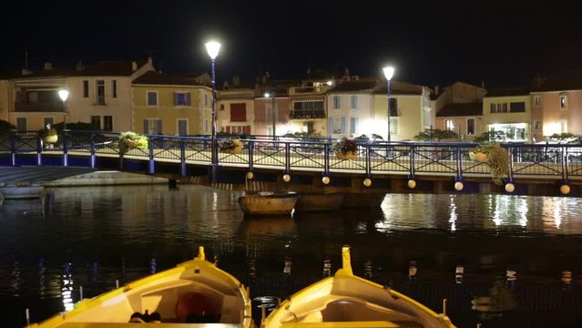 Picturesque evening view of coastal town of Martigues divided by canals with colorful residential buildings along waterfronts in summer, France