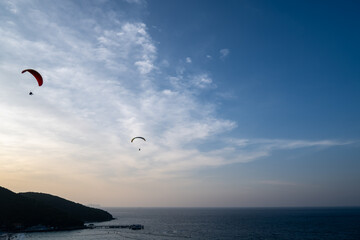 The sky with two gliders flying, below is the sea