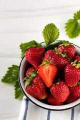 Fresh ripe strawberries in a bowl on a white background. Eco-products.