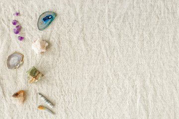 Top view different crystals and stones on table, healing minerals agate, quartz, amethyst, onyx. Stones for crystal therapy. Flat lay with semiprecious gems, alternative medicine concept