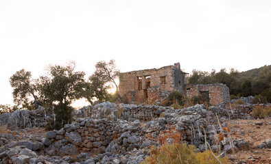 An old, almost ruined building on a hill. Through the stone windows the sunlight falls