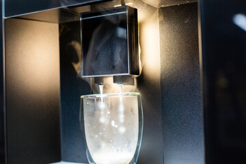 Close-up. Preparation of coffee latte in a modern coffee machine.