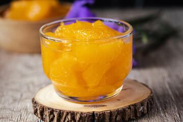 Orange in syrup in clear dessert glass