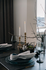 Easter table setting with crockery and colored eggs
