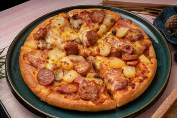 Top view of hot Mushroom and Sausage Pizza on wooden background.
