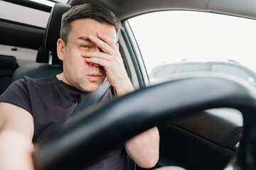 frightened man with closed eyes drives car on highway.dangerous accident on road