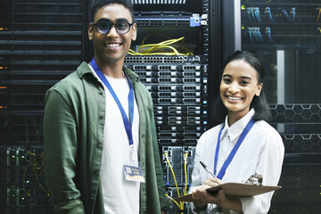 No virus, no problem. Shot of two technicians working together in a server room.
