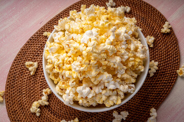 Popcorn in bown on wooden background. Popcorn in bowl on wooden table.